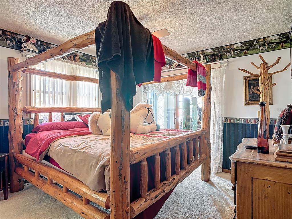 24545 Snail Road Astor, FL 32102 - Photo 18 of 61 a bedroom with a bed and a window