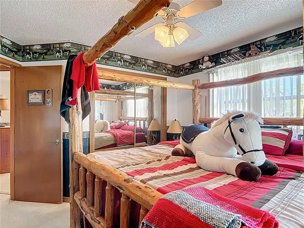 a bed room with a bed and a chandelier