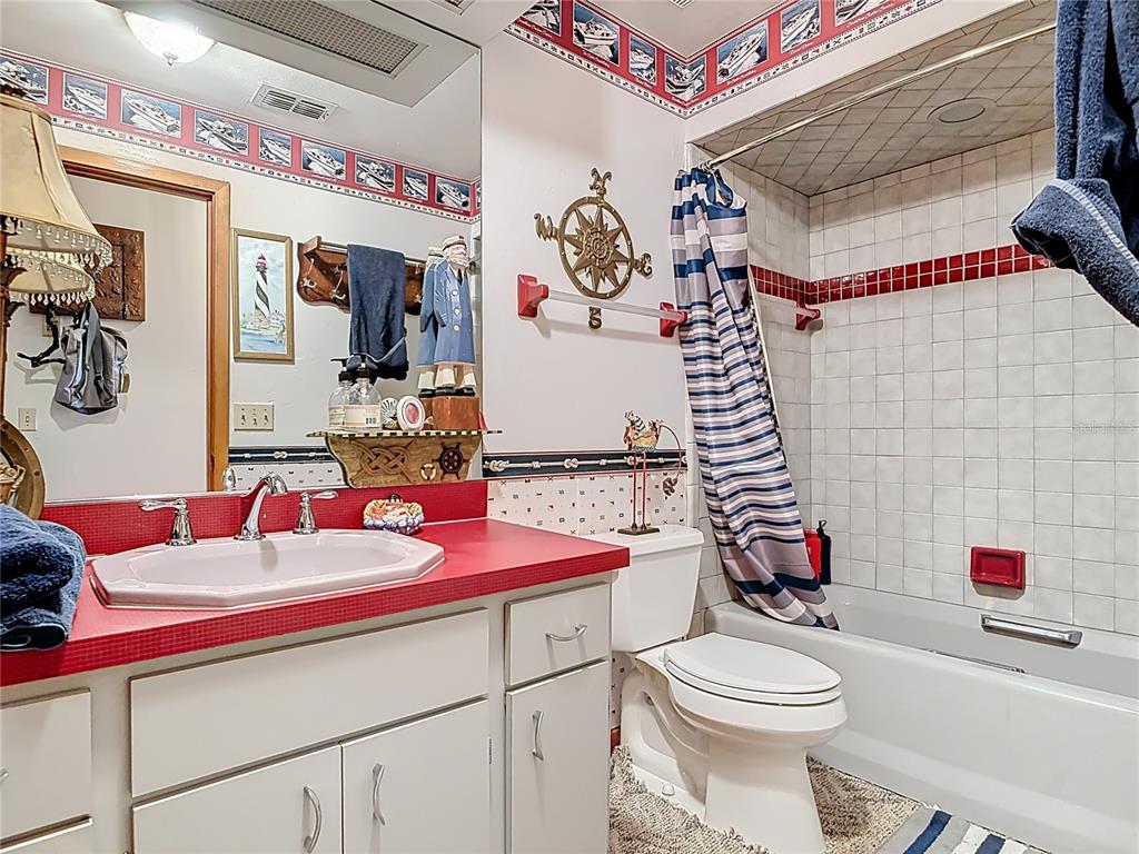 24545 Snail Road Astor, FL 32102 - Photo 20 of 61 a bathroom with a sink toilet and shower curtain