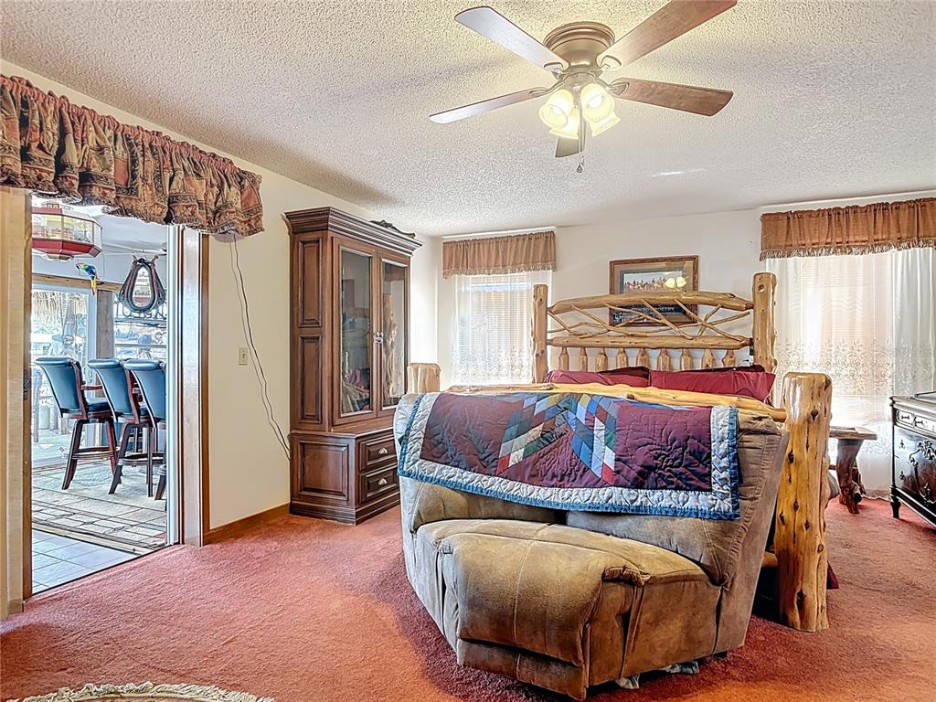 24545 Snail Road Astor, FL 32102 - Photo 23 of 61 a bed room with a bed and a chandelier
