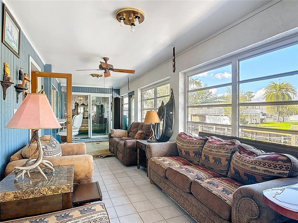 24545 Snail Road Astor, FL 32102 - Photo 26 of 61 a living room with furniture and a large window