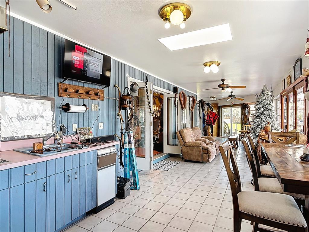 24545 Snail Road Astor, FL 32102 - Photo 29 of 61 a living room with furniture and a flat screen tv