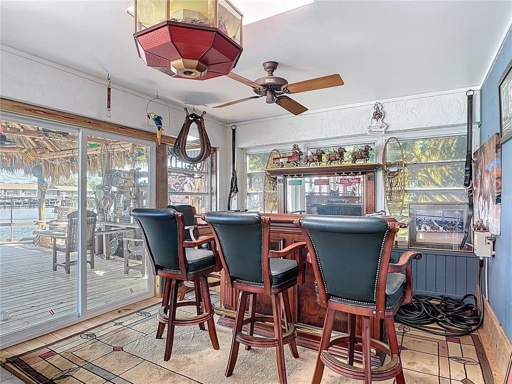 24545 Snail Road Astor, FL 32102 - Photo 30 of 61 a view of a dining room with furniture wooden floor and chandelier