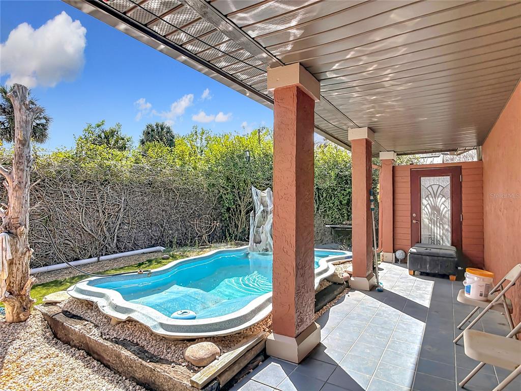 24545 Snail Road Astor, FL 32102 - Photo 33 of 61 a view of a patio with a table chairs and a backyard