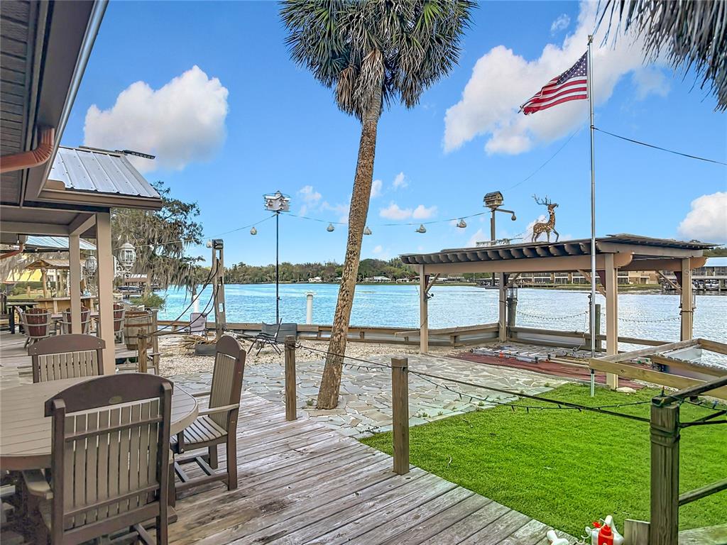24545 Snail Road Astor, FL 32102 - Photo 35 of 61 a view of a swimming pool with a table and chairs