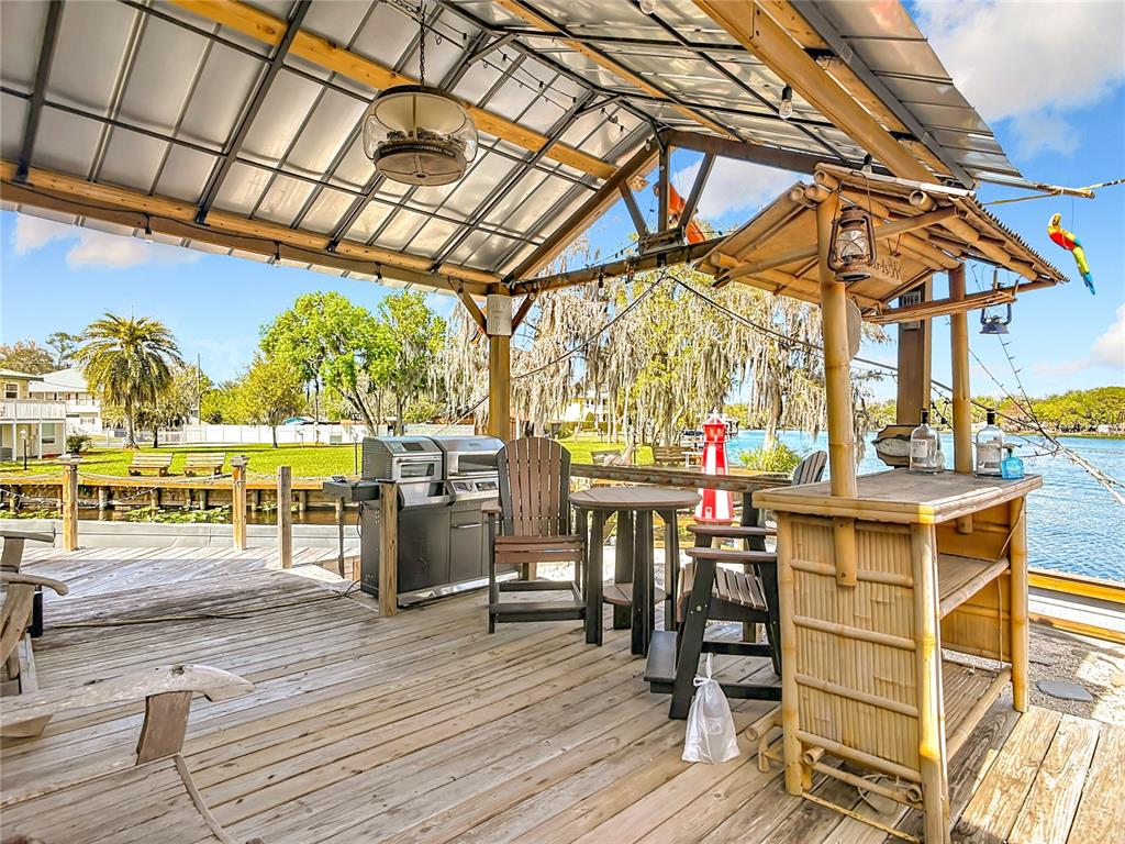 24545 Snail Road Astor, FL 32102 - Photo 42 of 61 a view of a swimming pool with a table and chairs