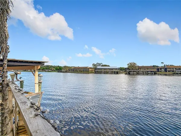 a view of a terrace with a table and chairs under an umbrella