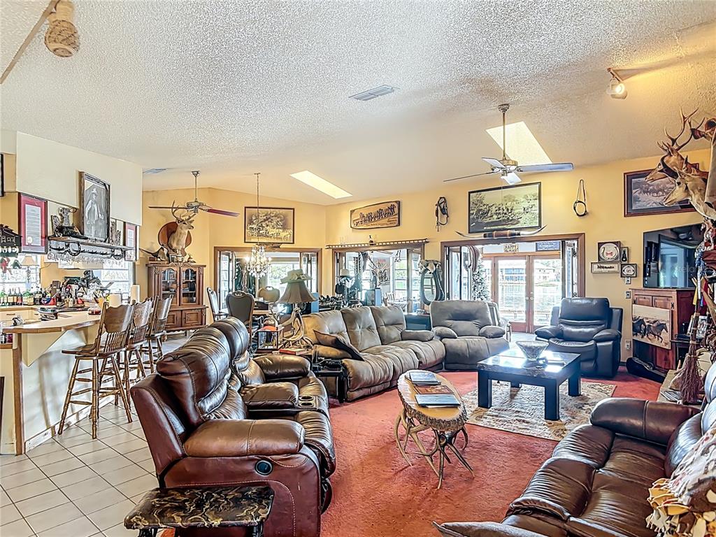 24545 Snail Road Astor, FL 32102 - Photo 6 of 61 a living room with furniture large window and a table