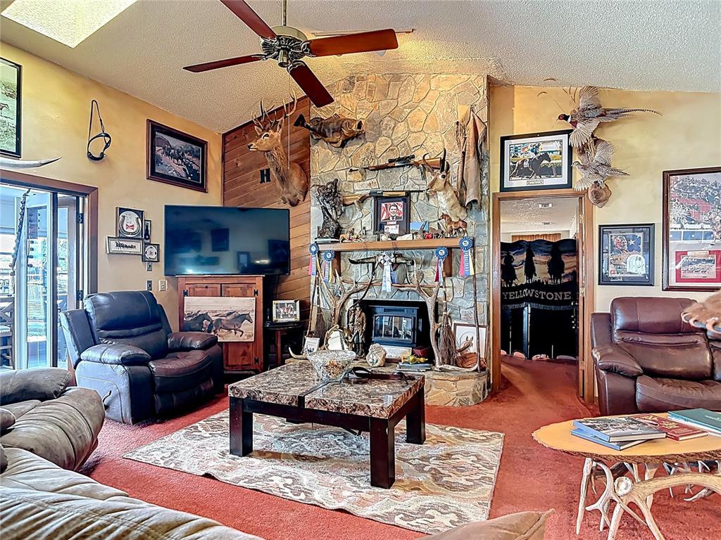 24545 Snail Road Astor, FL 32102 - Photo 10 of 61 a living room with furniture large window and a fireplace