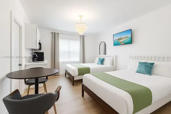 a bedroom with two beds and a table