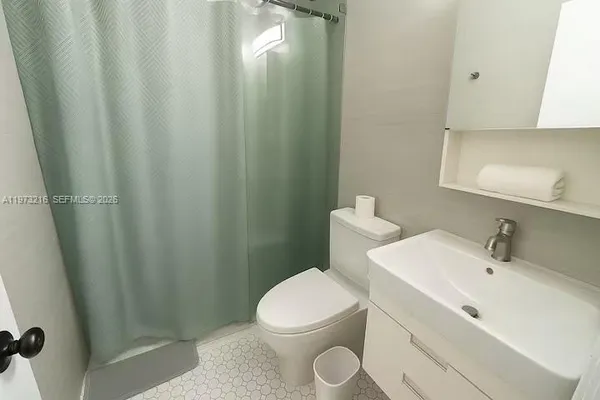 a bathroom with a toilet a sink and a mirror