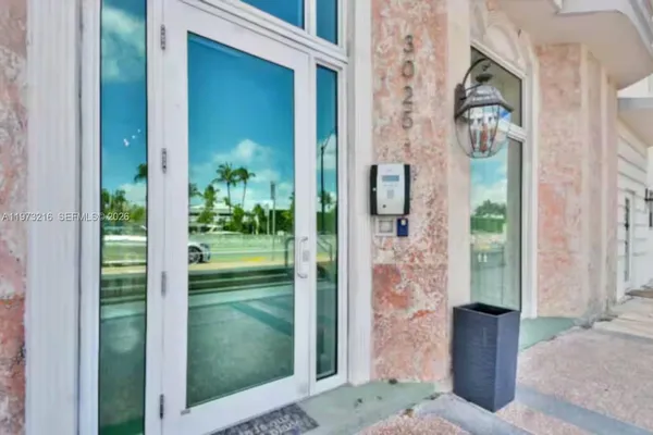 a view of a glass door front of a house