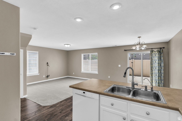 656 South 910 West, Unit 25 Pleasant Grove, UT 84062 - Photo 9 of 25 Kitchen island with a double basin stainless steel sink and a gooseneck faucet.