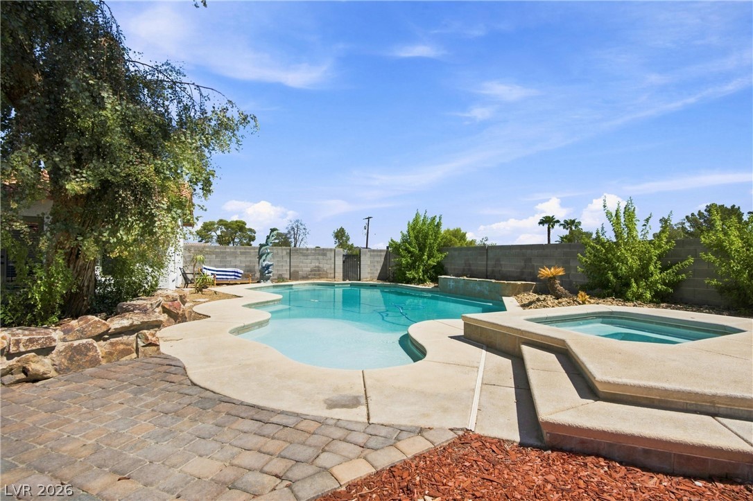 7744 Rancho Destino Road Las Vegas, NV 89123 - Photo 19 of 48 An inviting backyard retreat features a custom swimming pool paired with an integrated concrete spa.