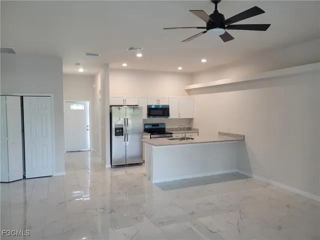a kitchen with stainless steel appliances a refrigerator and a stove top oven