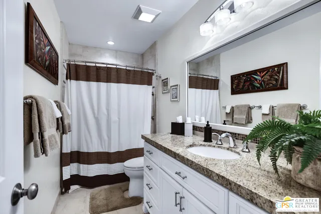 a bathroom with a sink a mirror and shower