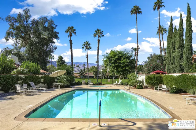 a view of a swimming pool with a lounge chairs