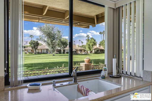 a view of a patio with a table and chairs