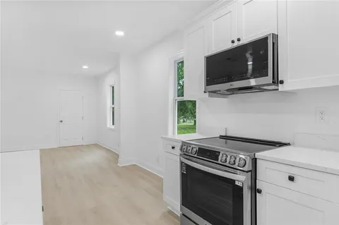 a kitchen with a stove and a microwave