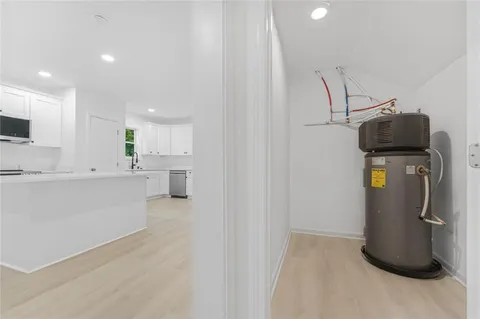a view of a kitchen with fridge and a sink