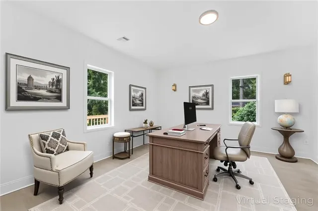 a view of a workspace with furniture and a window