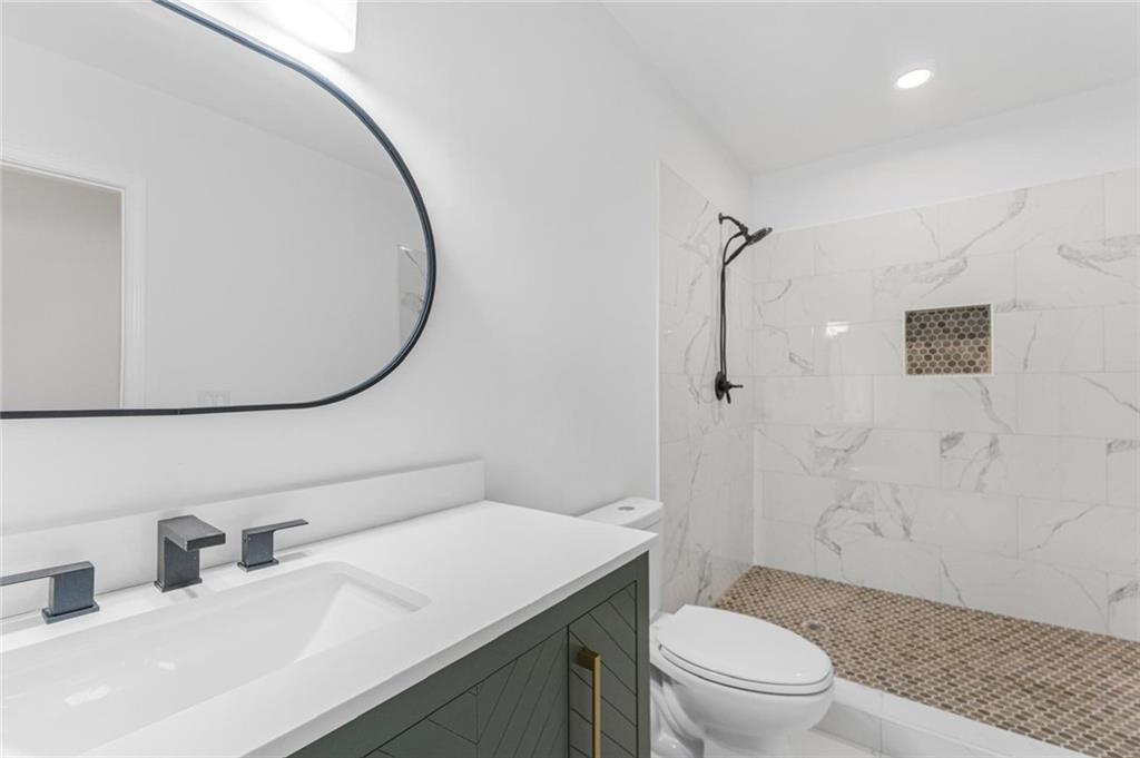 331 Highway 162 Covington, GA 30016 - Photo 21 of 26 a bathroom with a sink a toilet and shower