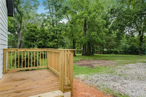 a view of a backyard with large trees