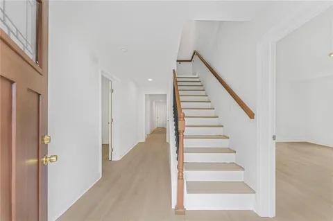 a view of staircase with white walls and windows