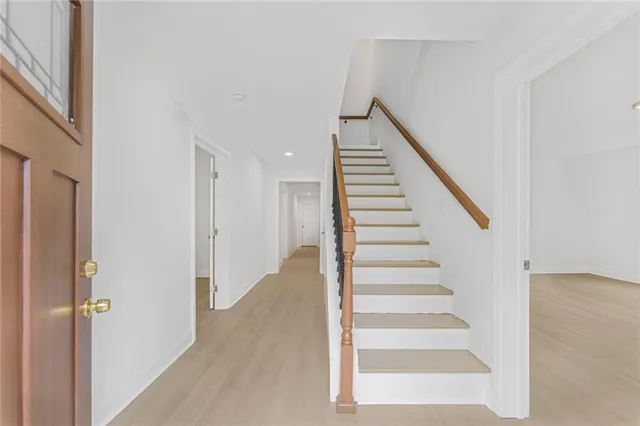 a view of staircase with white walls and windows