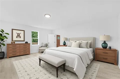 a bedroom with a large bed and a dresser