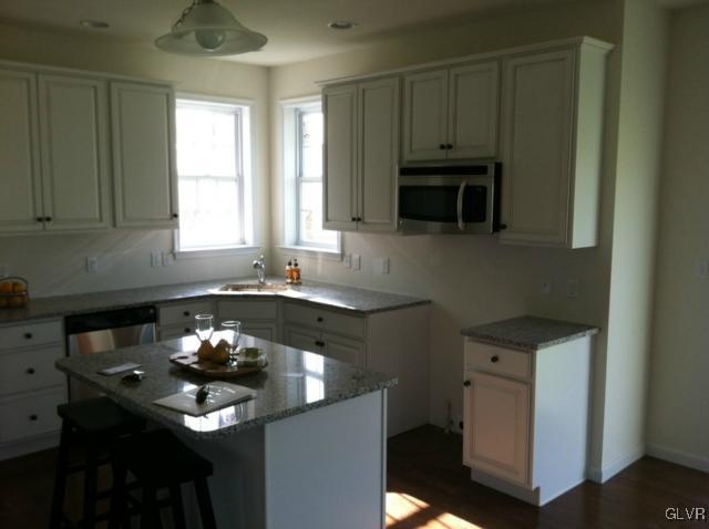 4110 Walter Road Bethlehem, PA 18020 - Photo 3 of 6 a kitchen with granite countertop a stove a sink and a microwave