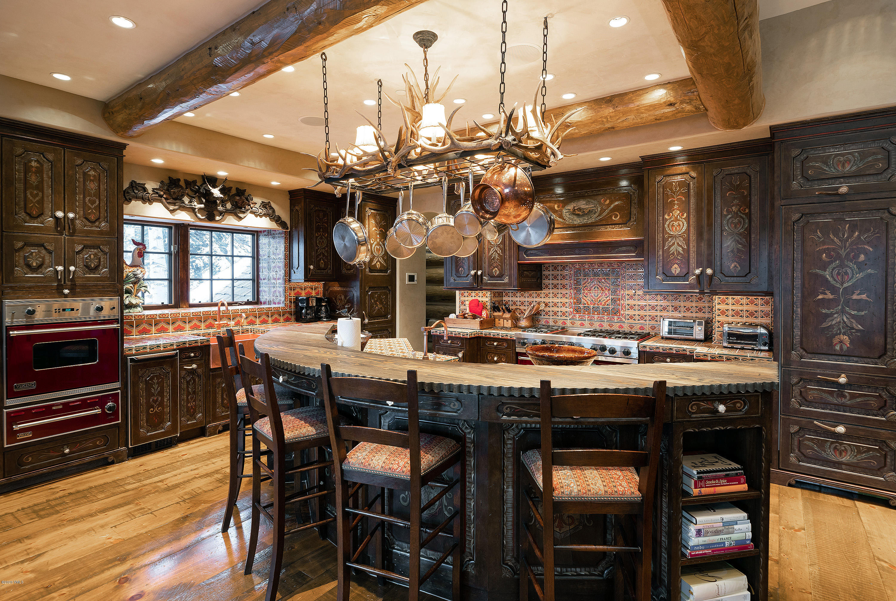 3389 Daybreak Ridge Road Avon, CO 81620 - Photo 4 of 24 a kitchen with stainless steel appliances granite countertop a sink a stove and chairs