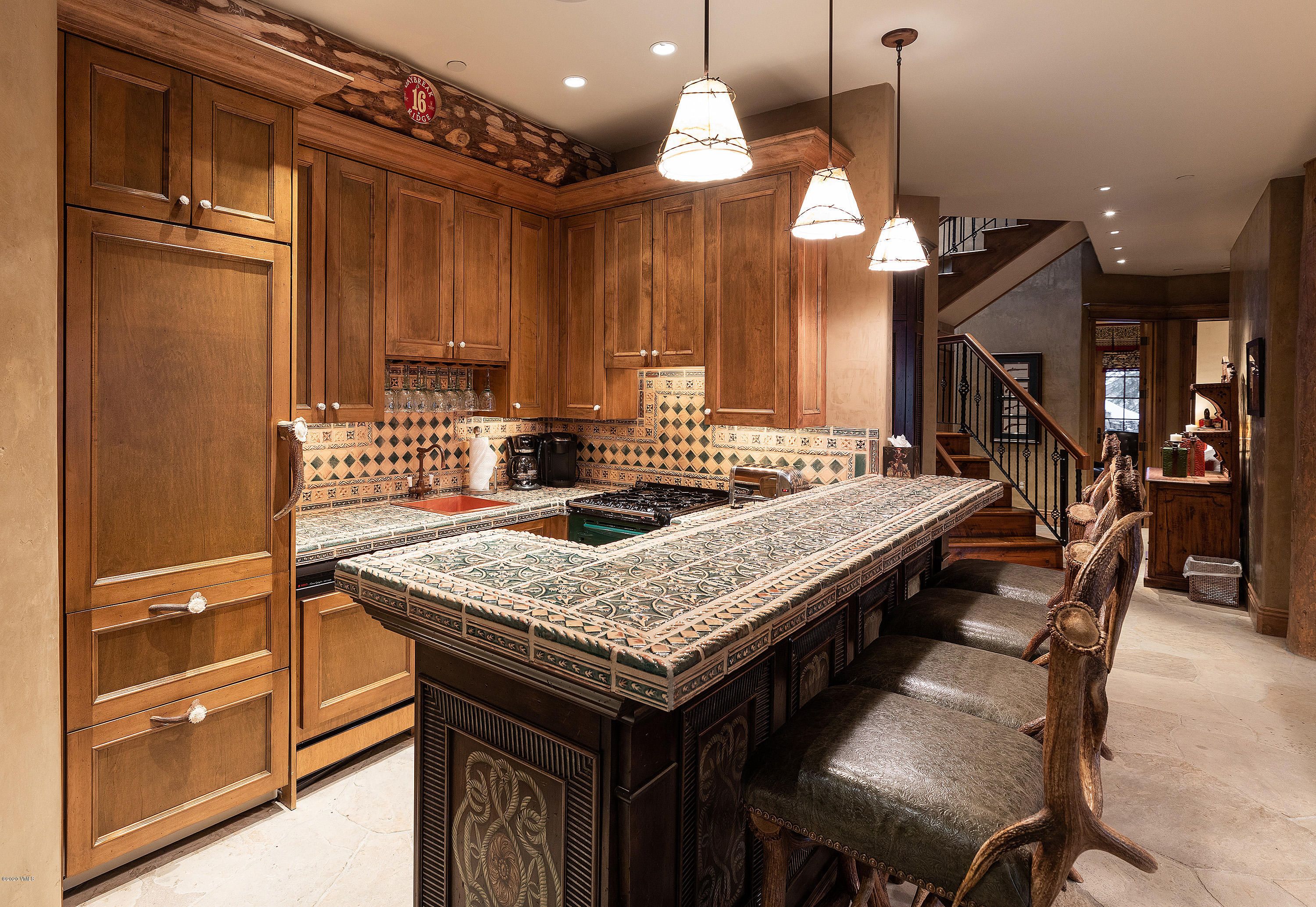 3389 Daybreak Ridge Road Avon, CO 81620 - Photo 6 of 24 a kitchen with a table chairs and a refrigerator