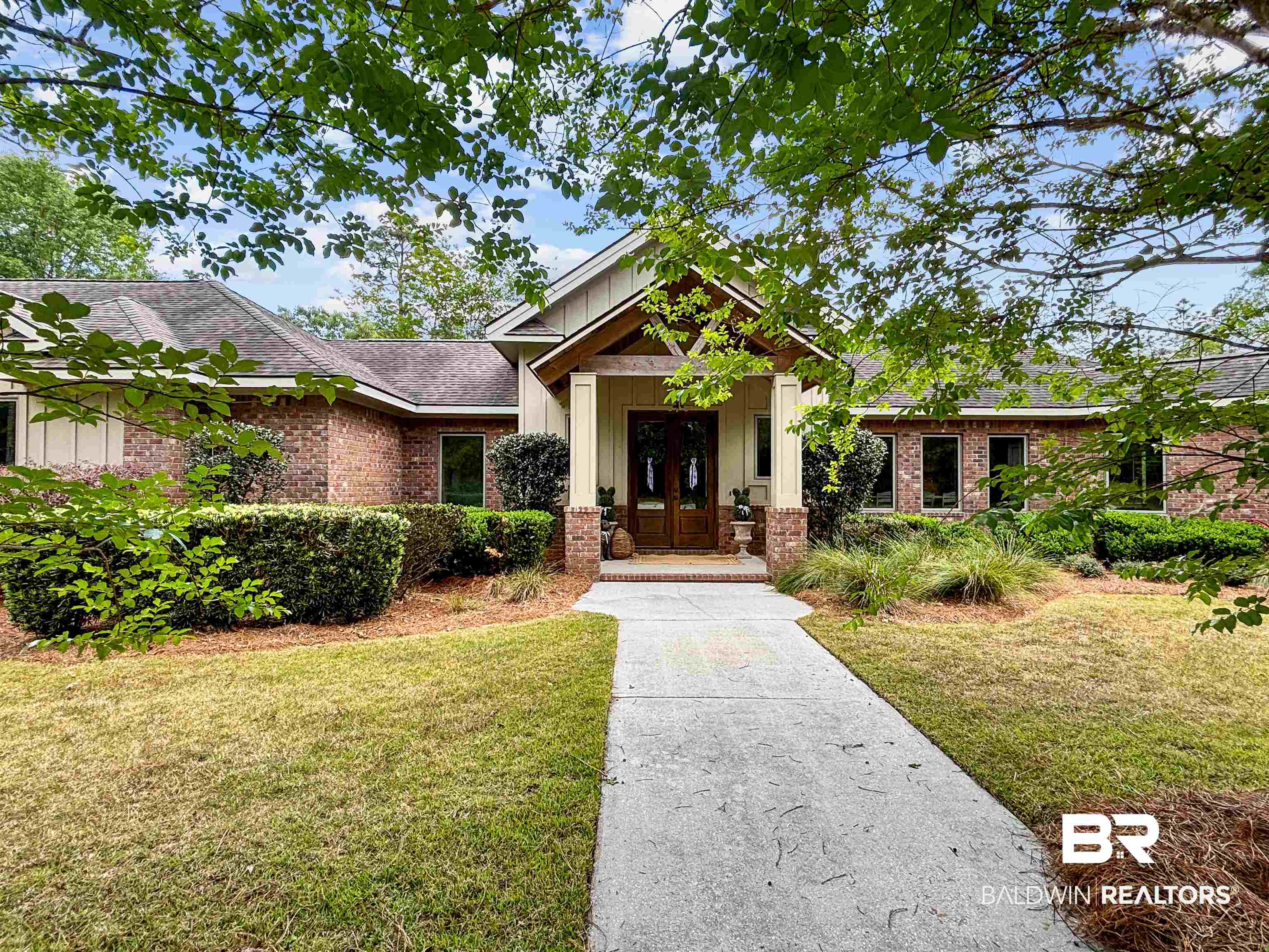 47252 Emmons Road Bay Minette, AL 36507 - Photo 1 of 50 Craftsman house with board and batten siding, french doors, a front lawn, and brick siding