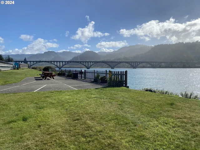 a terrace with outdoor seating and lake
