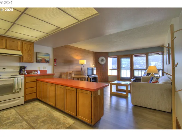 a open kitchen with cabinets a sink and a stove
