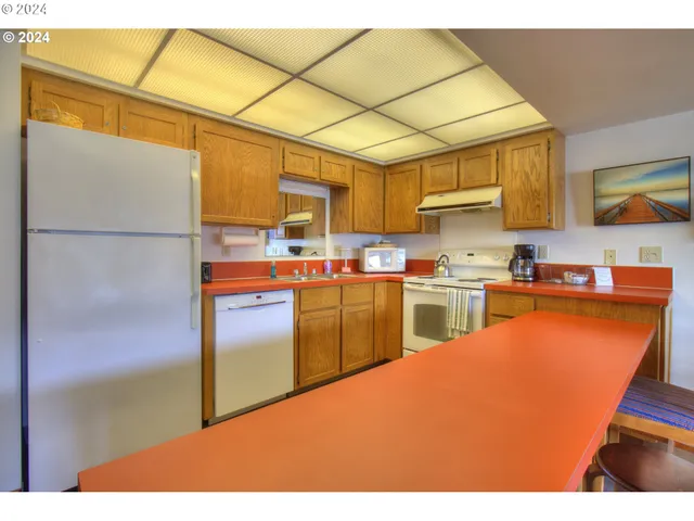 a kitchen with cabinets and a refrigerator