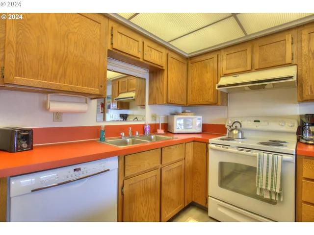 a kitchen with a sink cabinets and appliances