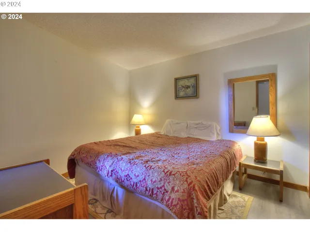 a bedroom with a bed and a lamp