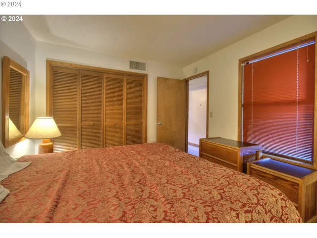 a bedroom with a bed and window