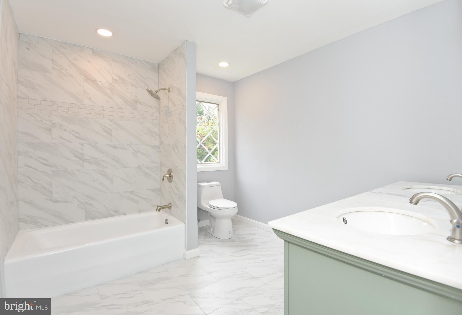 71 Carter Road Lawrence Township, NJ 08648 - Photo 22 of 33 a bathroom with a granite countertop sink a toilet and bathtub