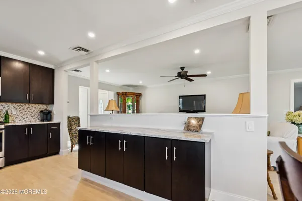 a kitchen with stainless steel appliances granite countertop a refrigerator stove and sink
