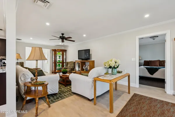 a kitchen with stainless steel appliances kitchen island granite countertop a refrigerator and a sink