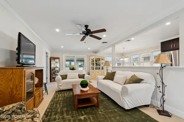 a living room with furniture ceiling fan and a rug