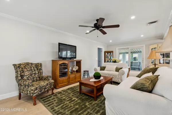 a living room with furniture and a view of kitchen