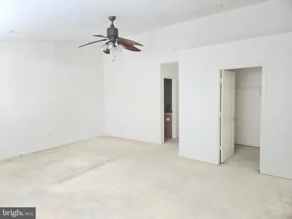 a view of a room with a ceiling fan