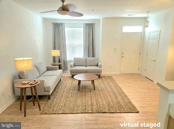 a living room with furniture and a rug