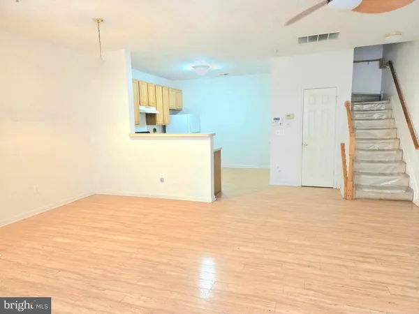 a view of a kitchen cabinets and wooden floor