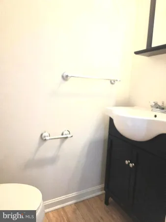 a bathroom with a sink a toilet and mirror