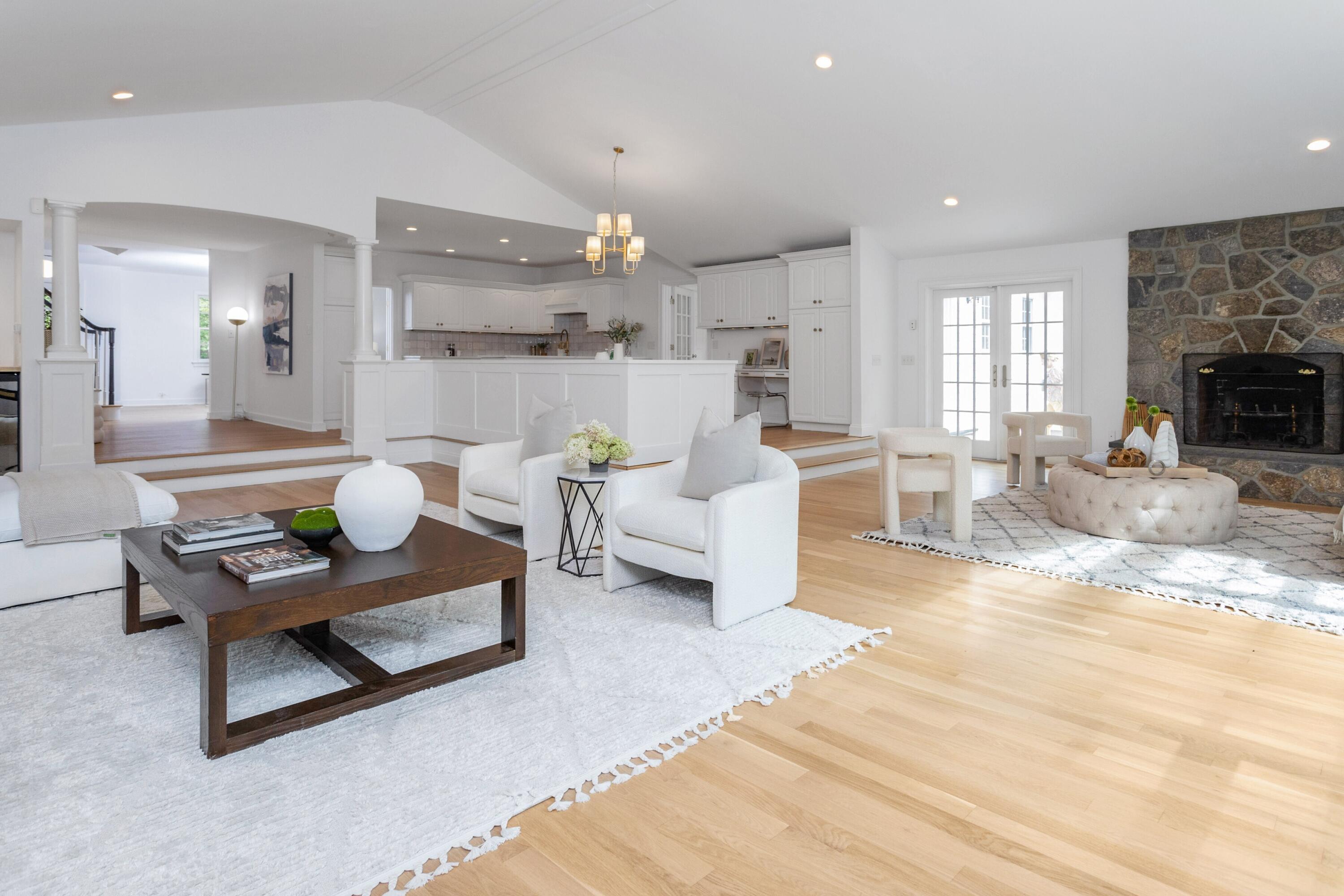215 Leroy Avenue Darien, CT 06820 - Photo 18 of 34 a living room with furniture a fireplace and a dining table with kitchen view